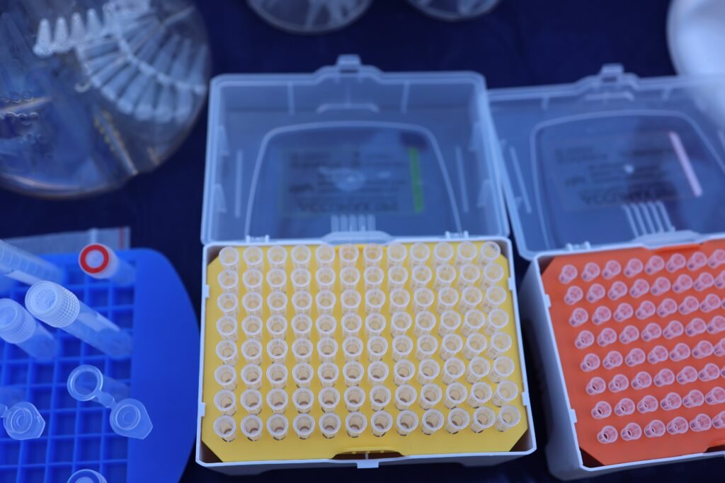 Stacked racks of disposable pipette tips in their moulded boxes.